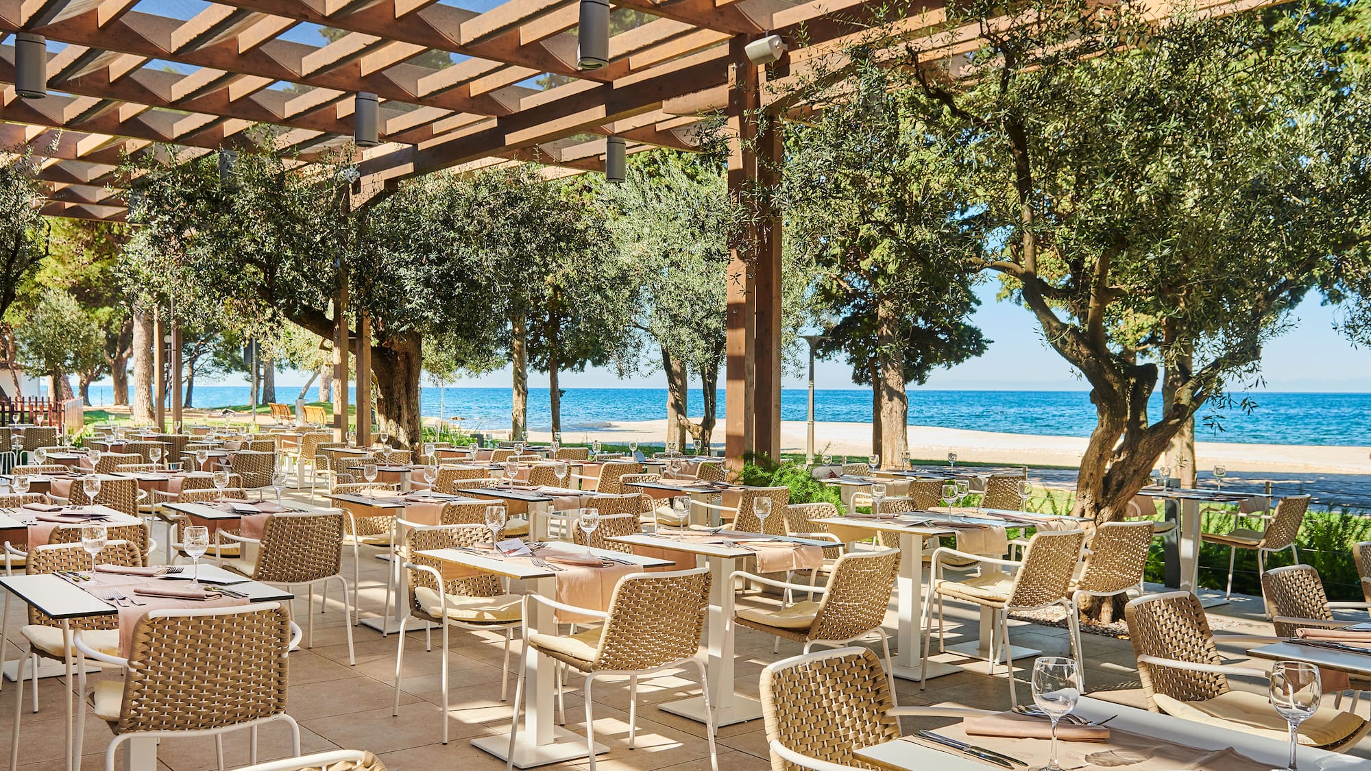a restaurant with tables and chairs under a canopy