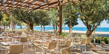 a restaurant with tables and chairs under a canopy
