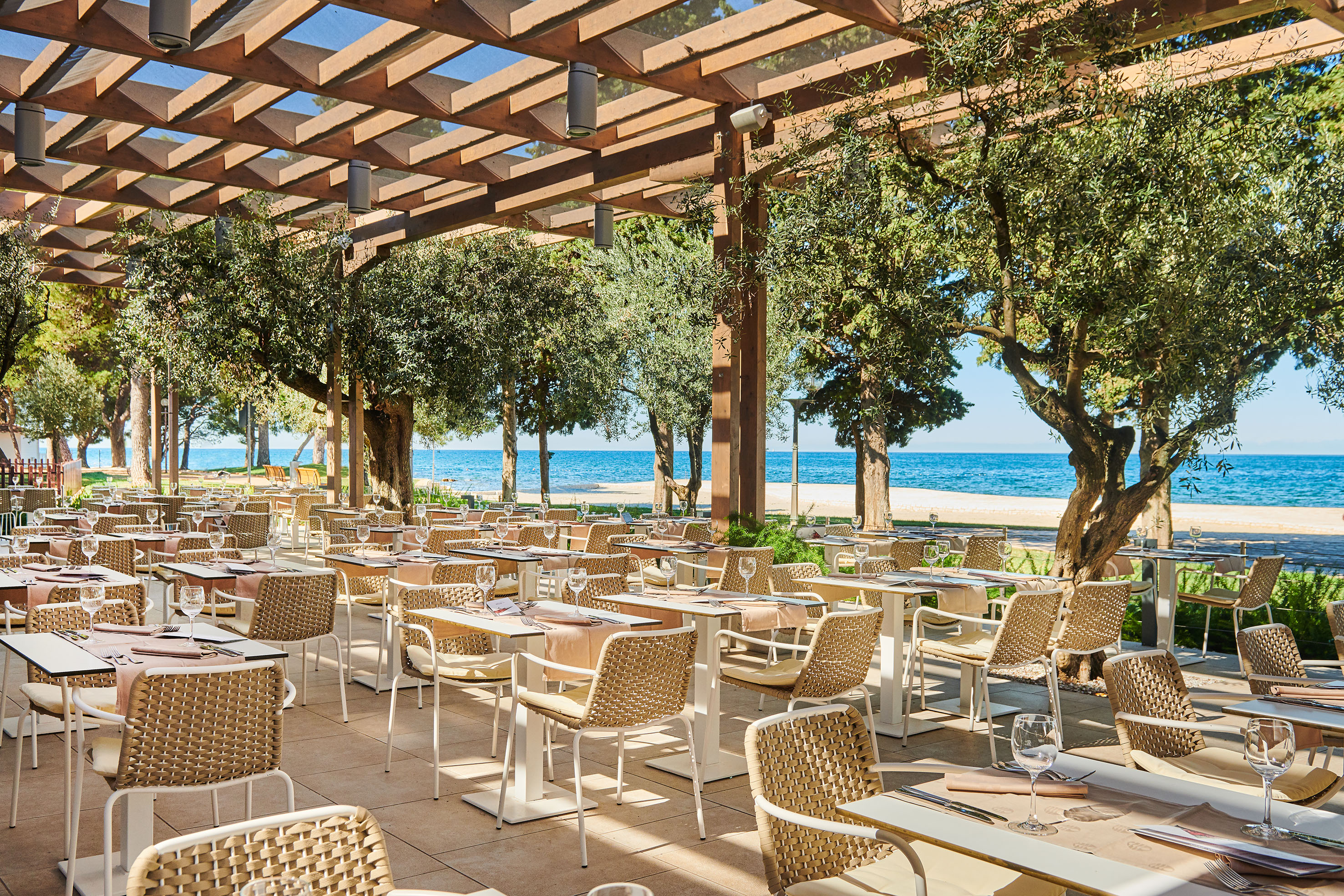 a restaurant with tables and chairs under a canopy