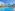 Sunny resort pool with white buildings, palm trees, and lounge chairs.