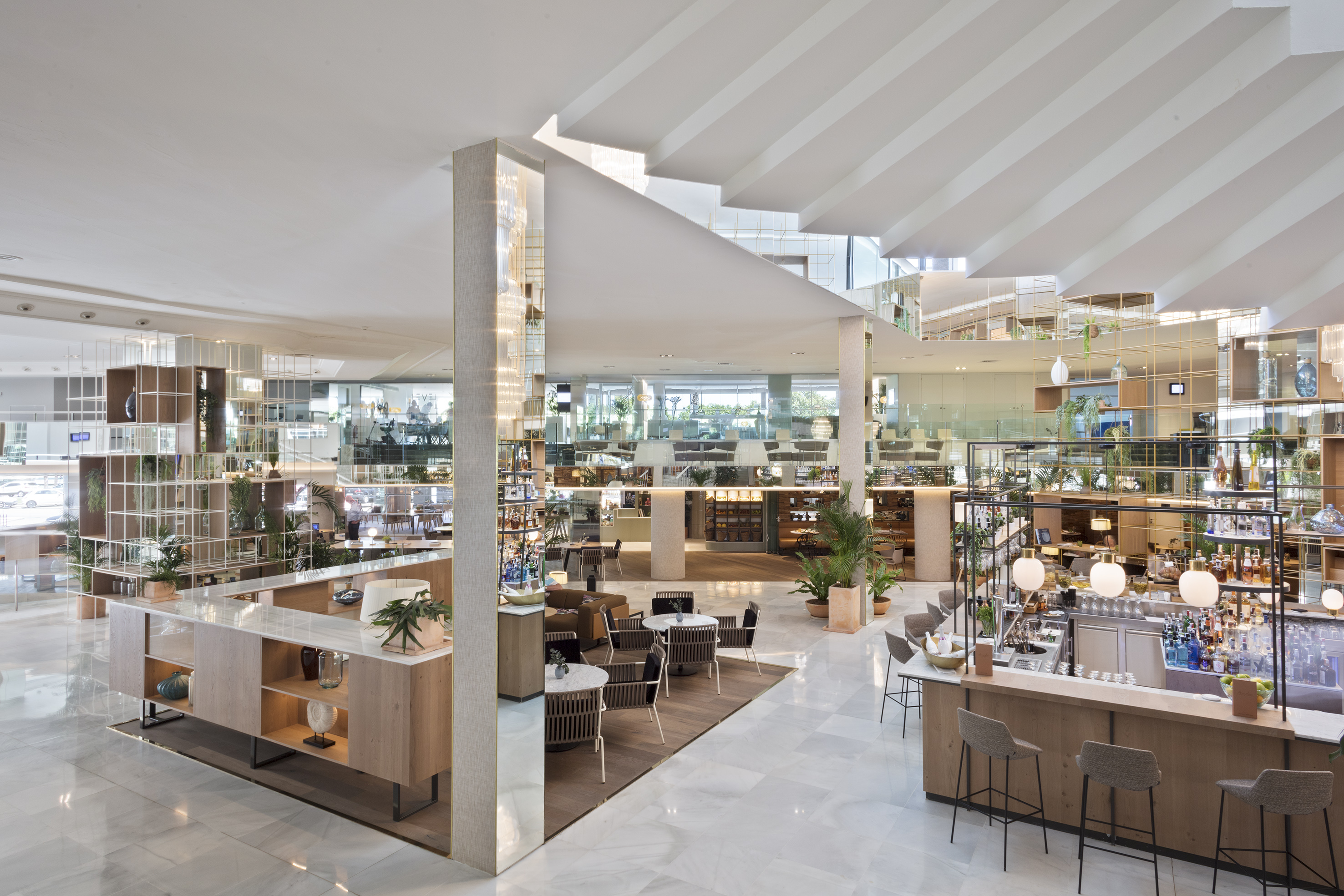Modern hotel lobby with stylish bar, lounge seating, and open-plan design.