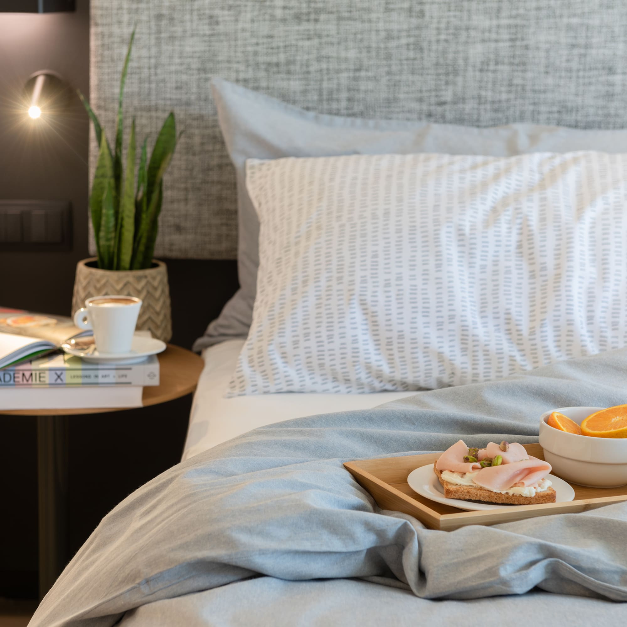 a tray of food on a bed