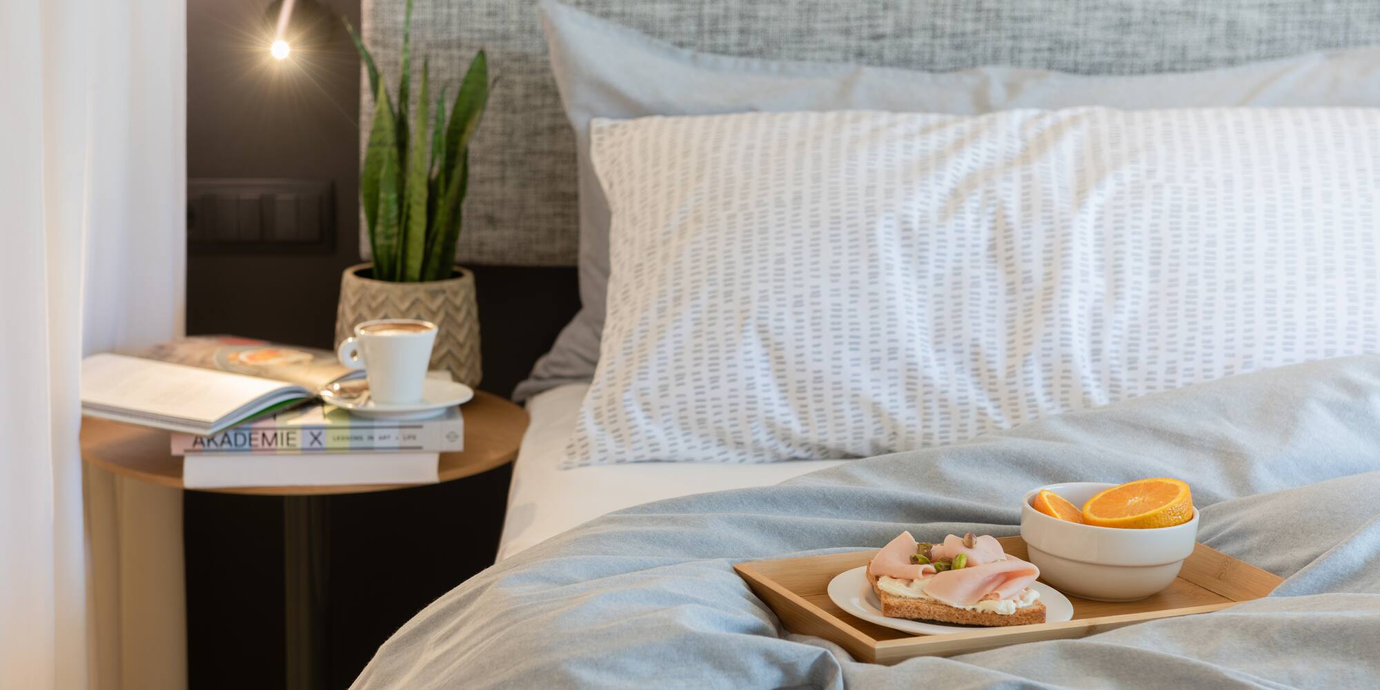 a tray of food on a bed