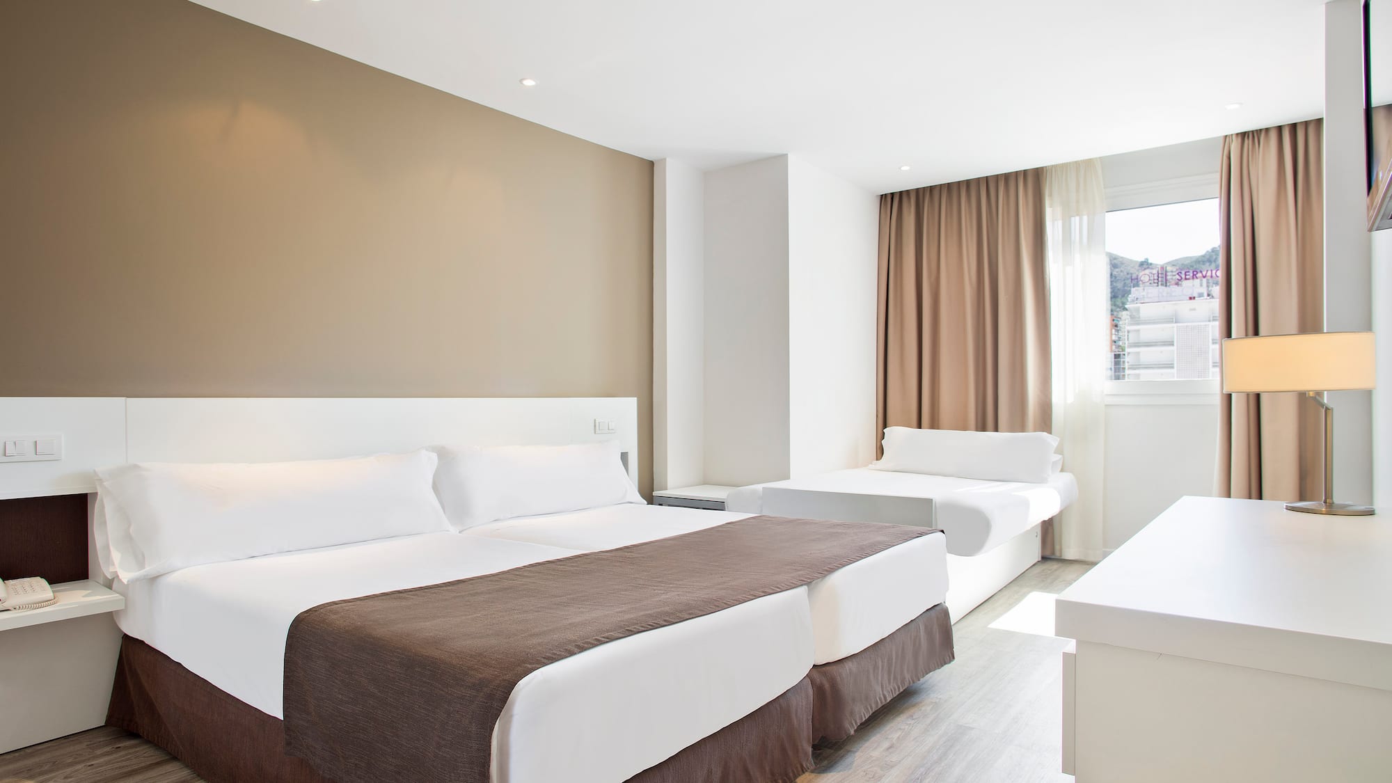 a room with two beds and a window