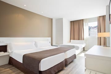 a room with two beds and a window