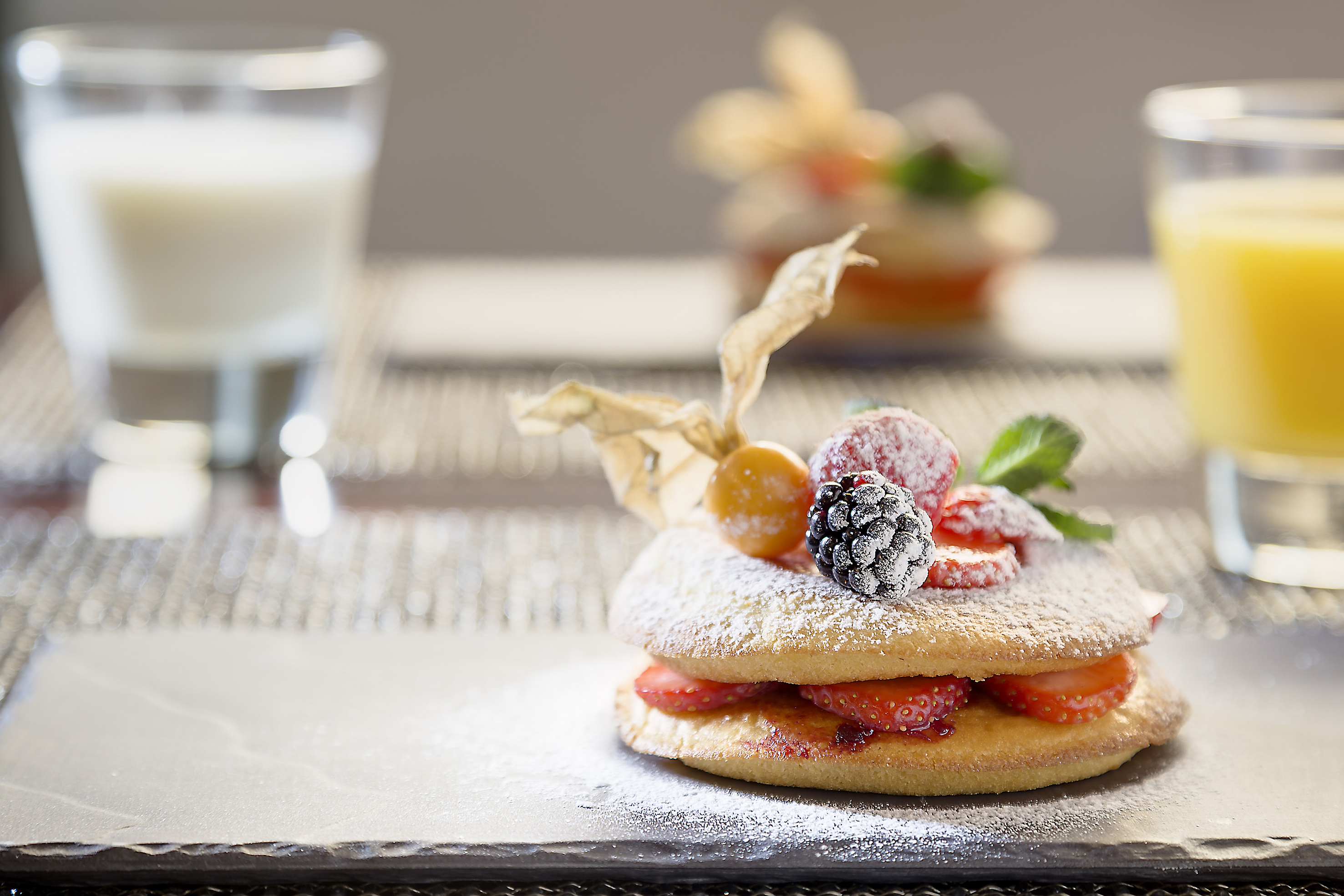 a dessert with berries and powdered sugar on top
