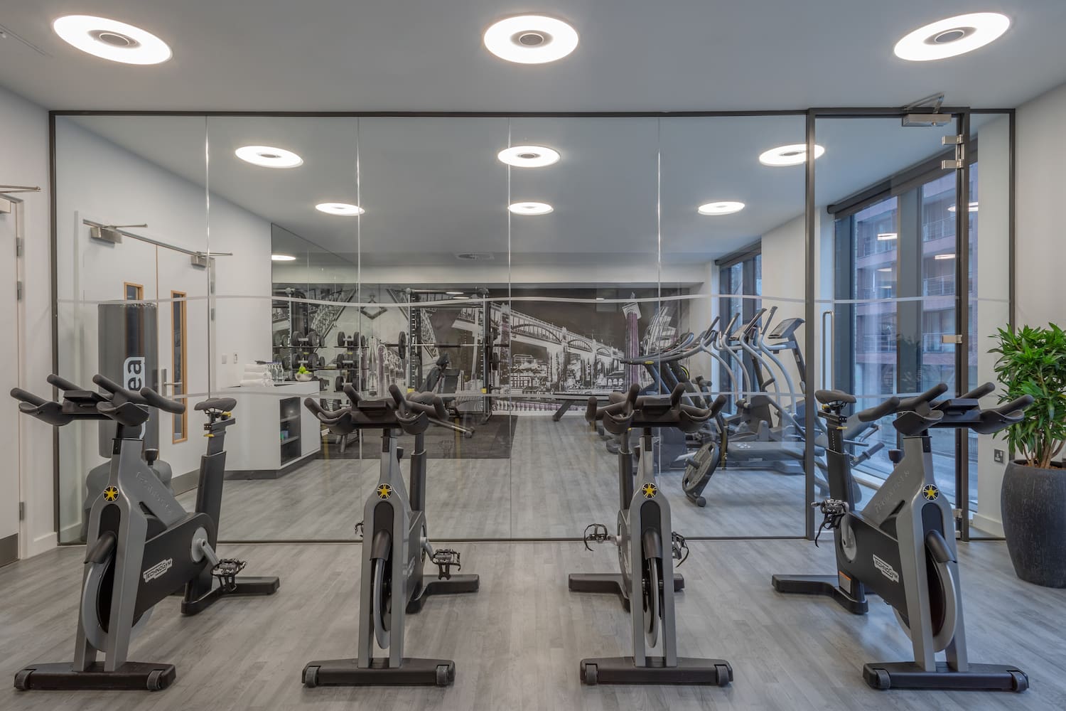 a room with exercise bikes and a mirror