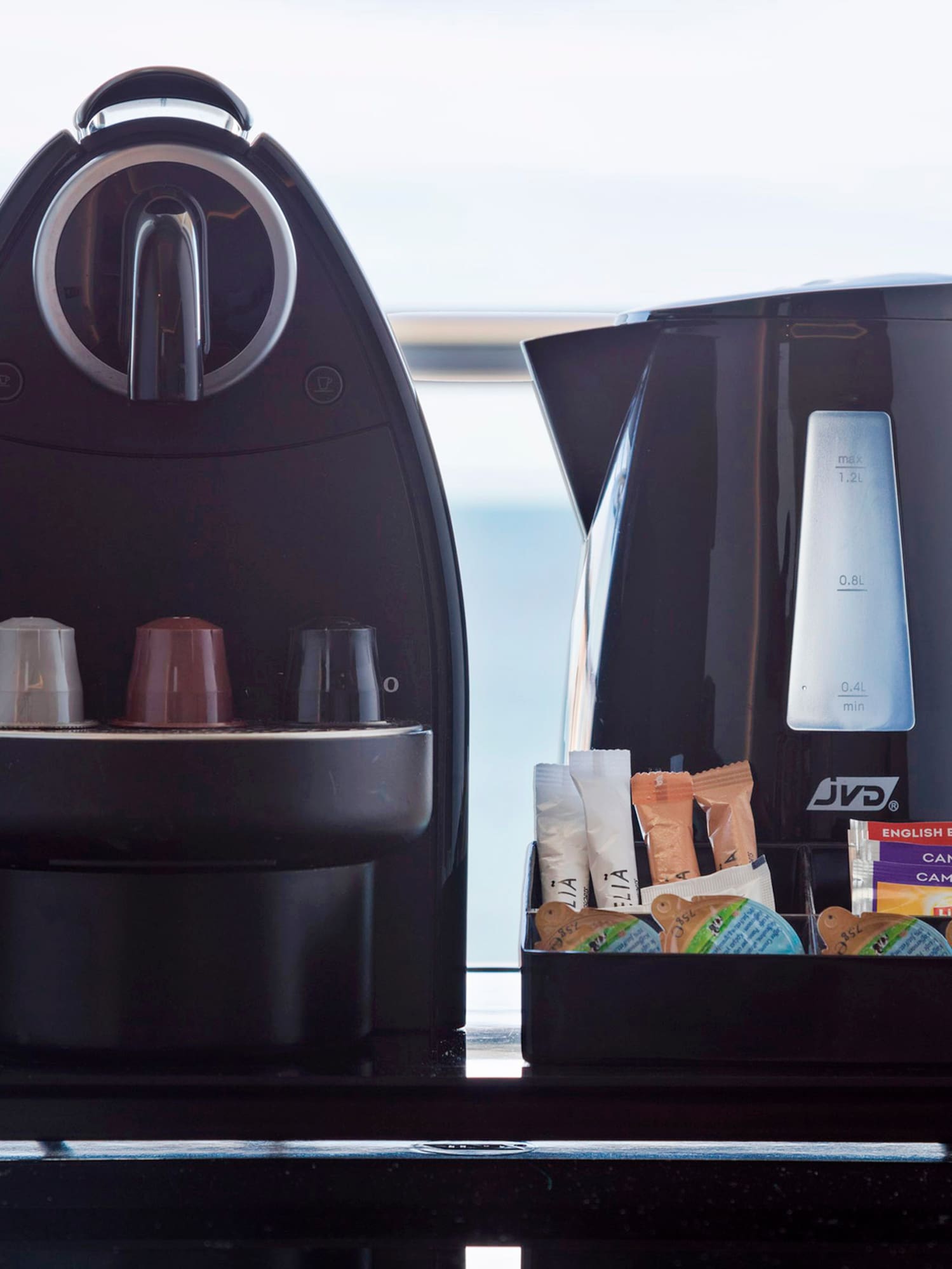 a coffee maker and a container of food