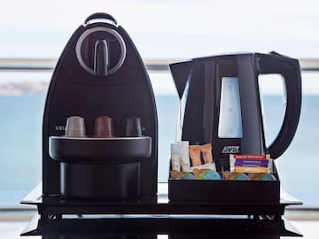 a coffee maker and a container of food