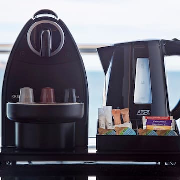 a coffee maker and a container of food