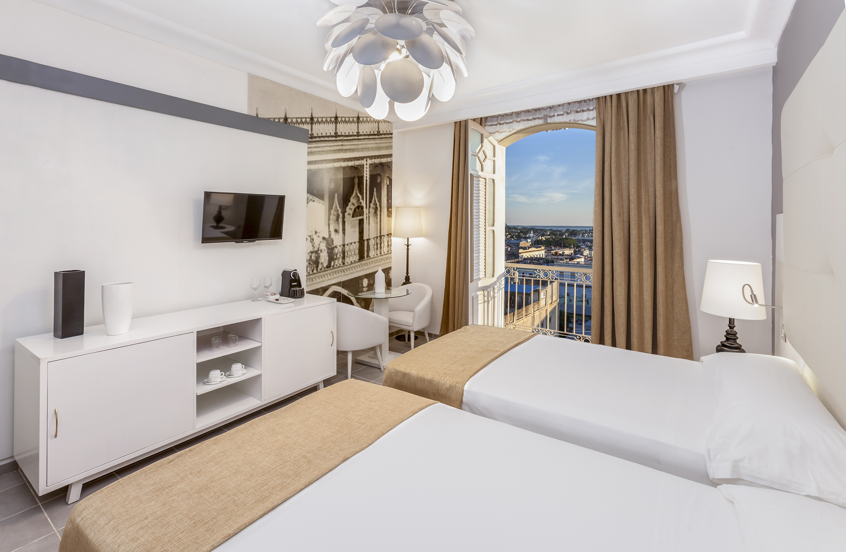 a room with two beds and a window