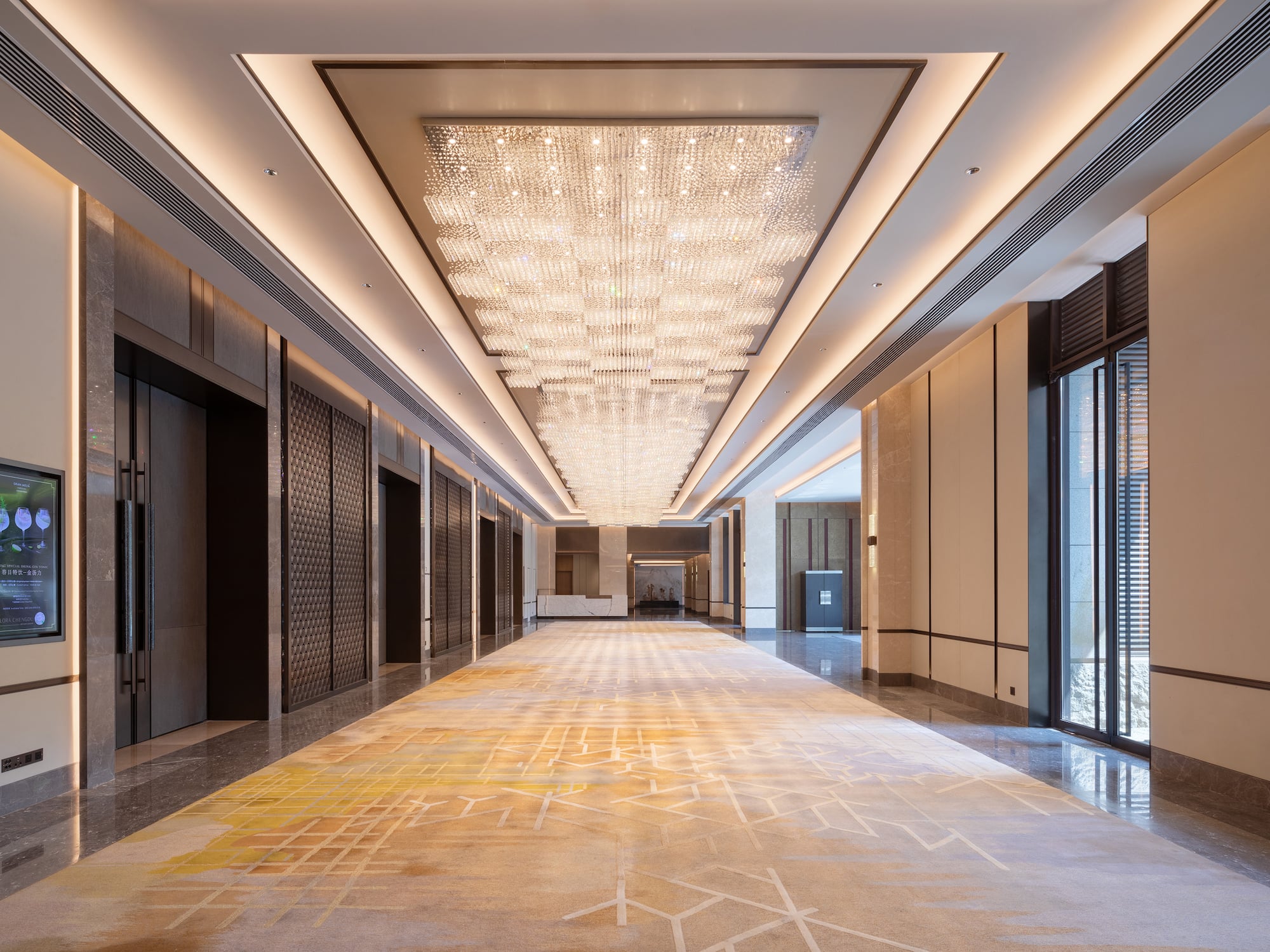 a hallway with lights and glass doors