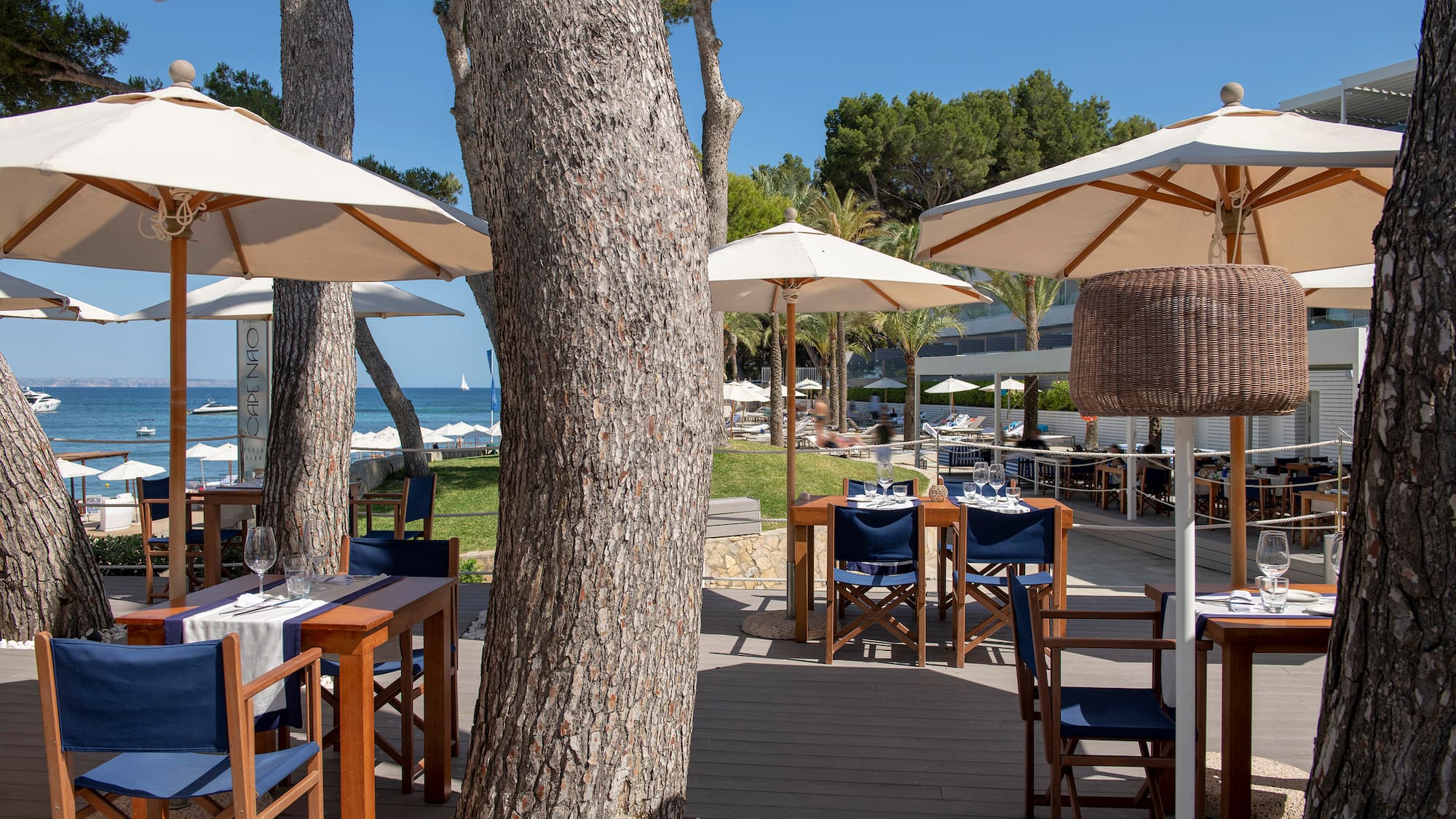 a tables and chairs outside with umbrellas