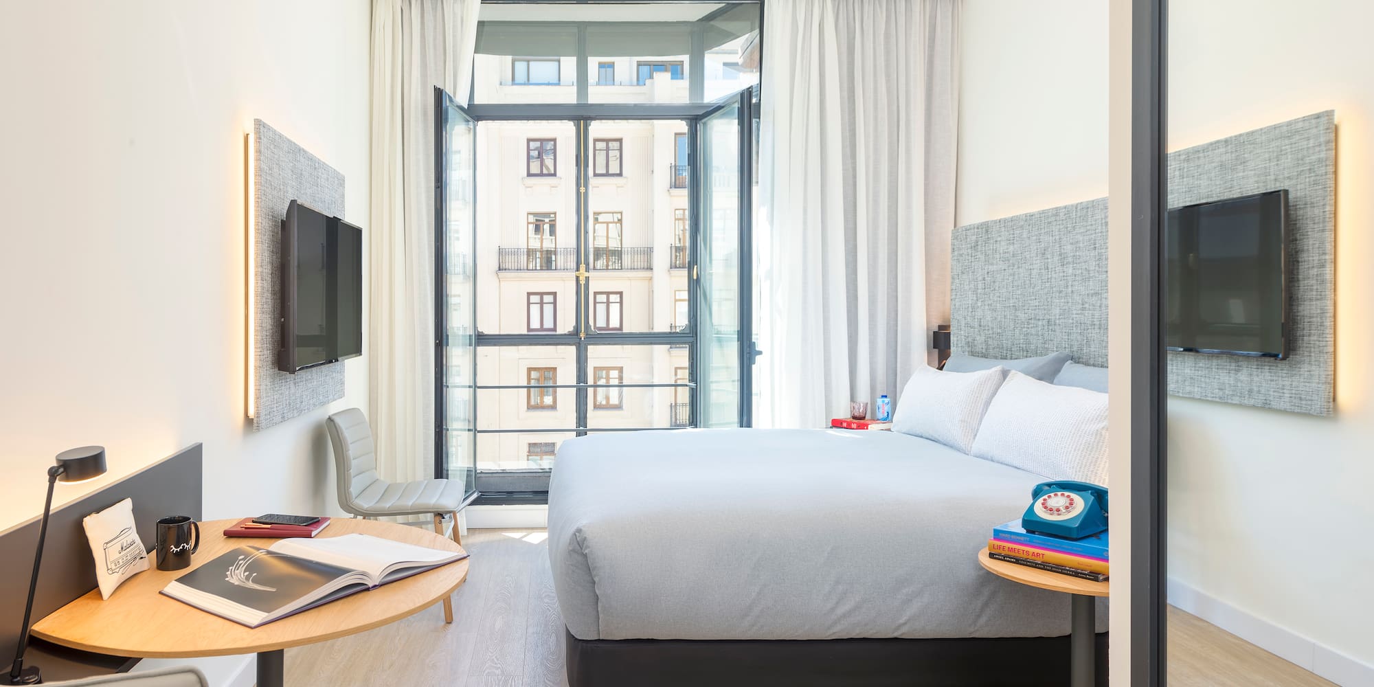 a bedroom with a bed and a tv