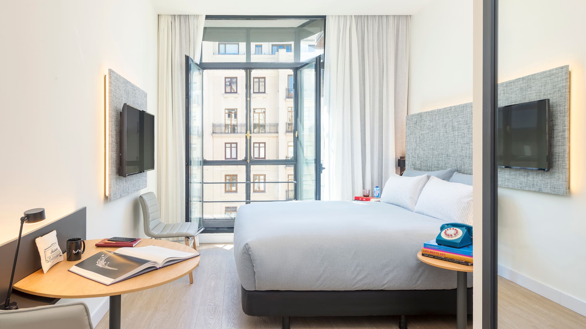 a bedroom with a bed and a tv