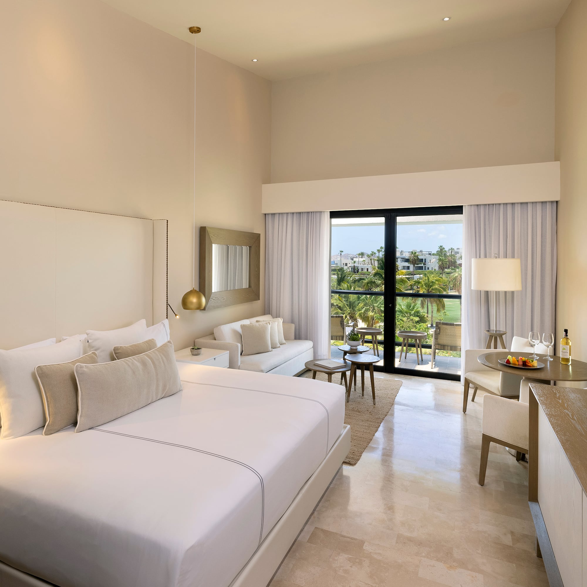 a room with a bed and a table and chairs