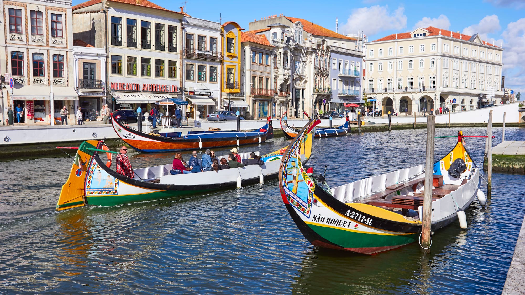 boats in a canal with buildings and boats
