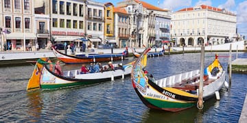 boats in a canal with buildings and boats
