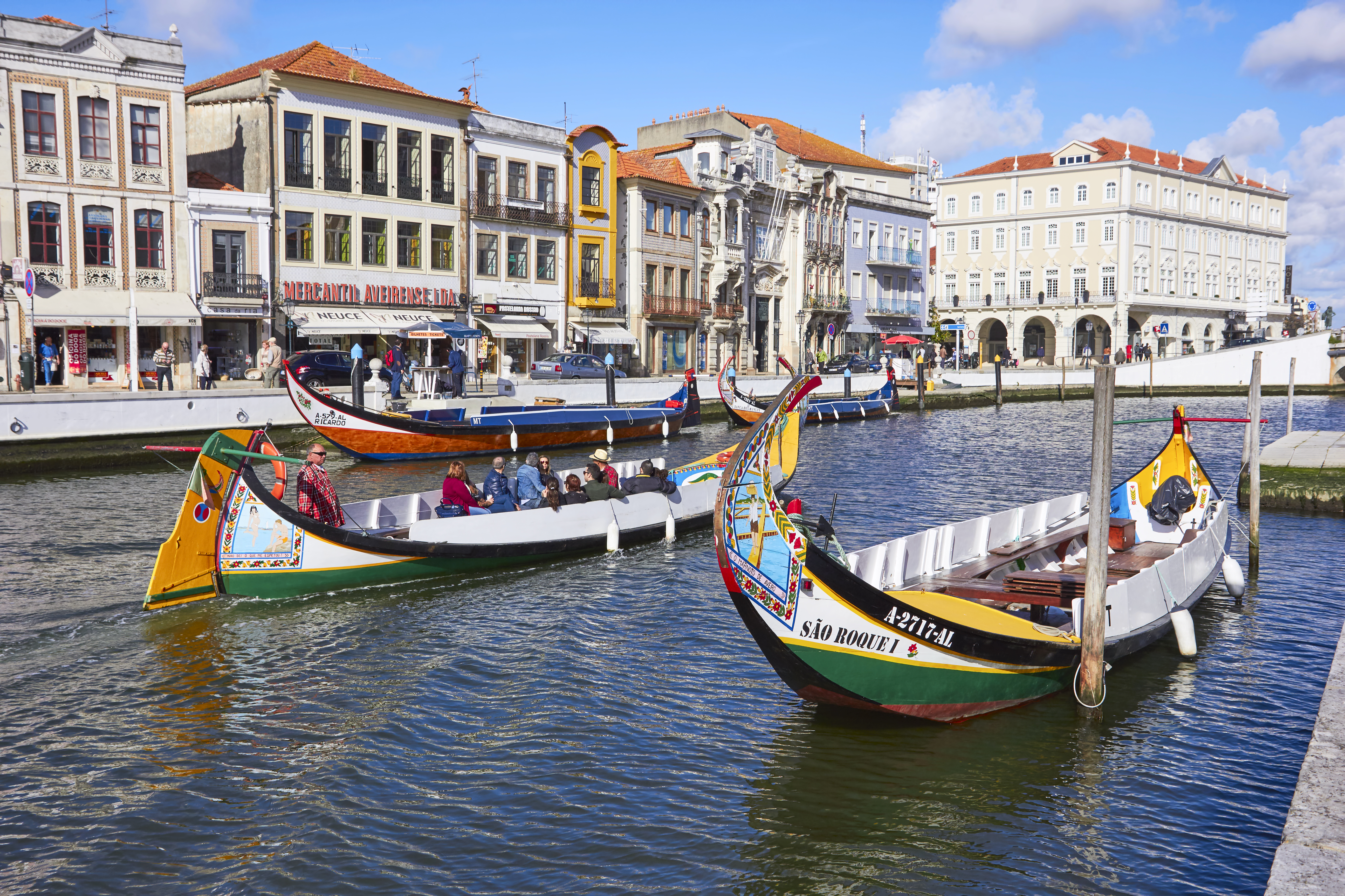 boats in a canal with buildings and boats