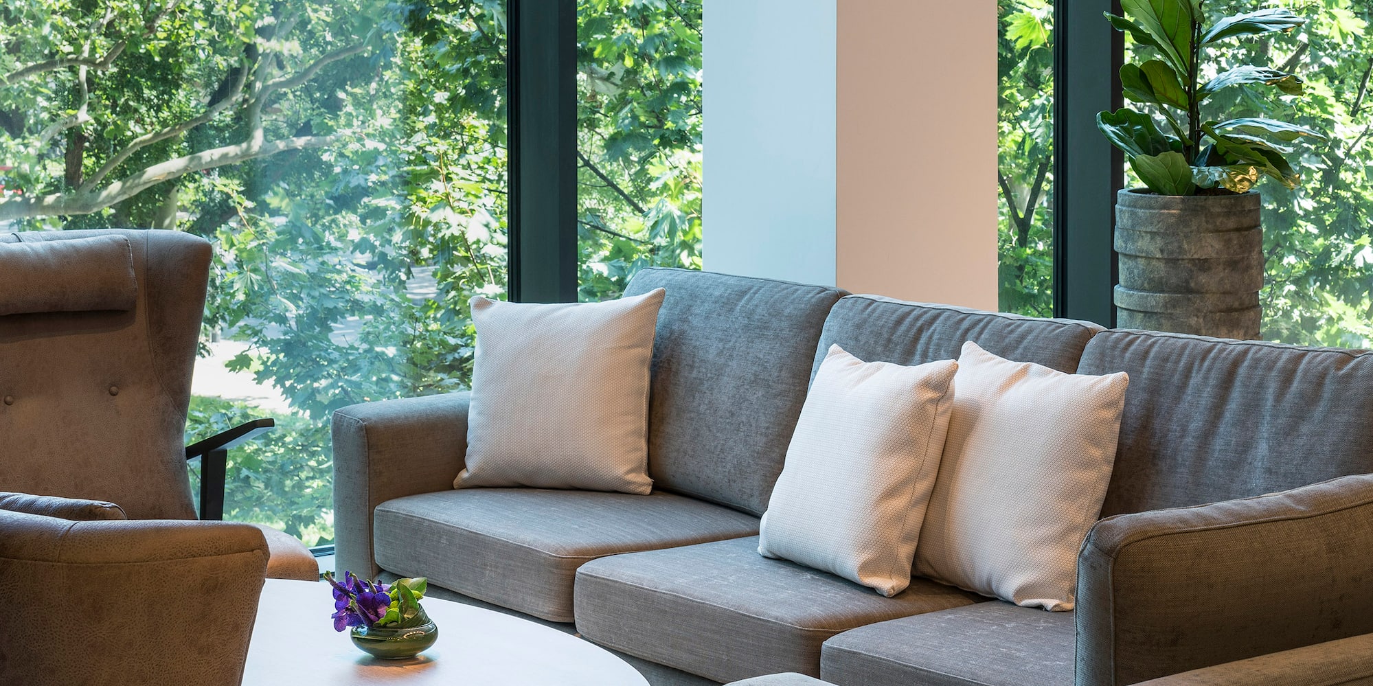 a couch and chair in a room with windows