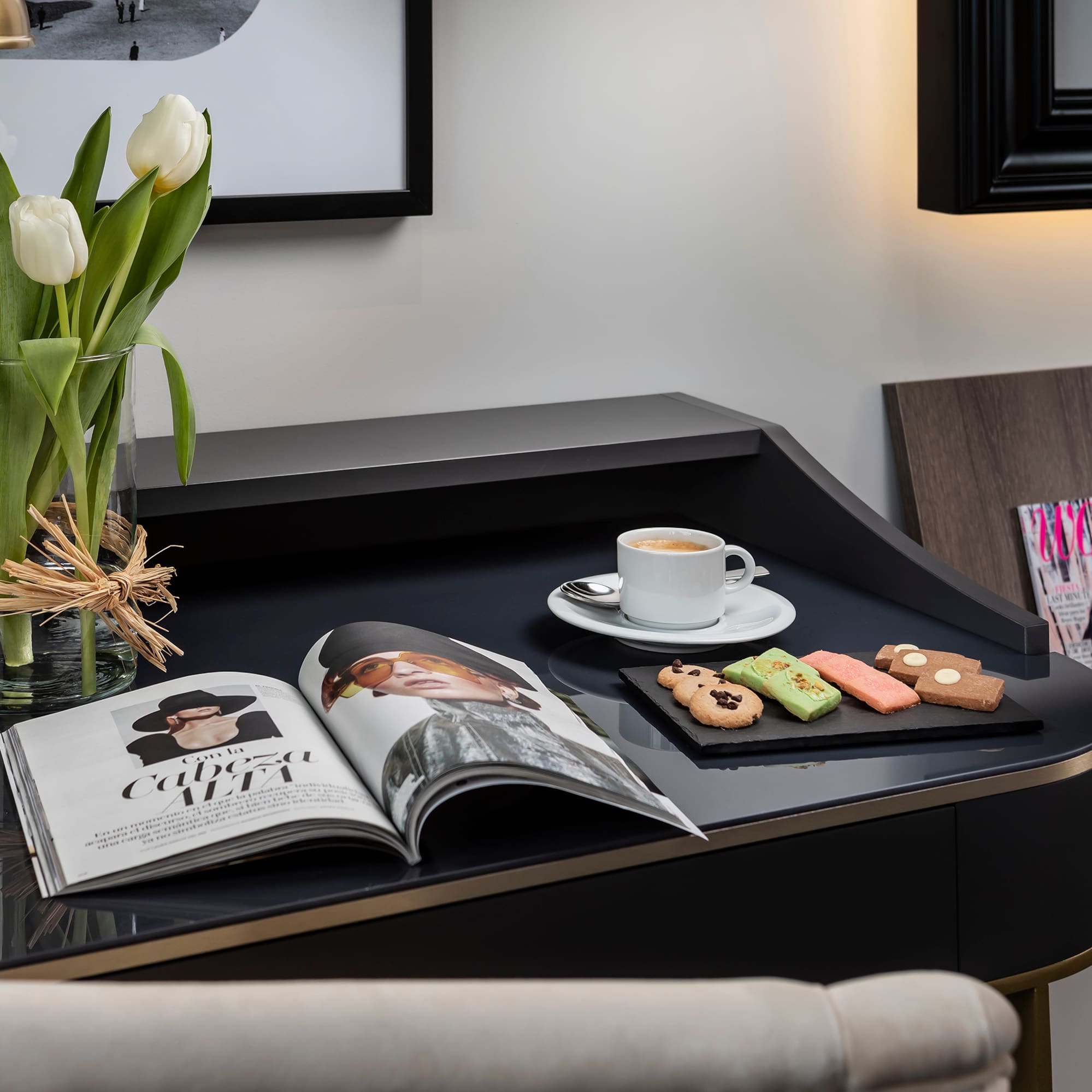 a coffee and cookies on a black table