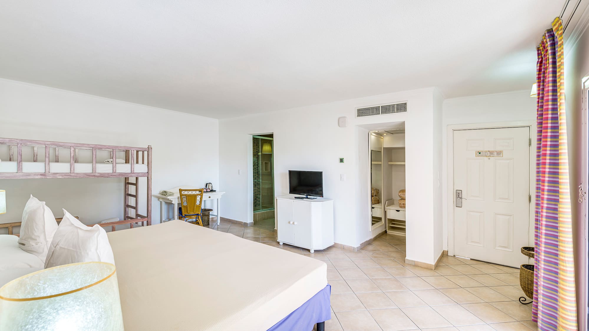 a room with a bed and a bunk bed