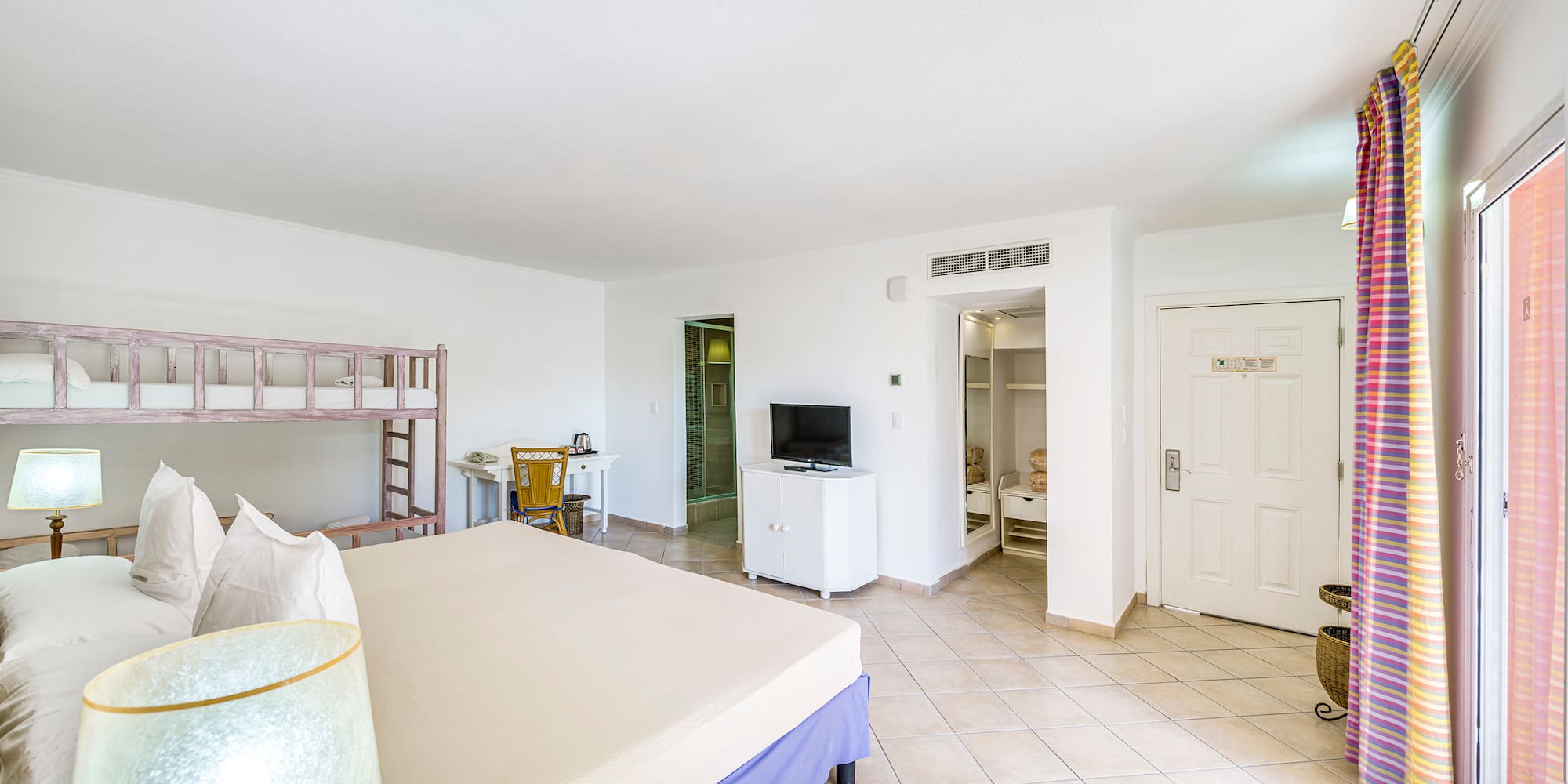 a room with a bed and a bunk bed