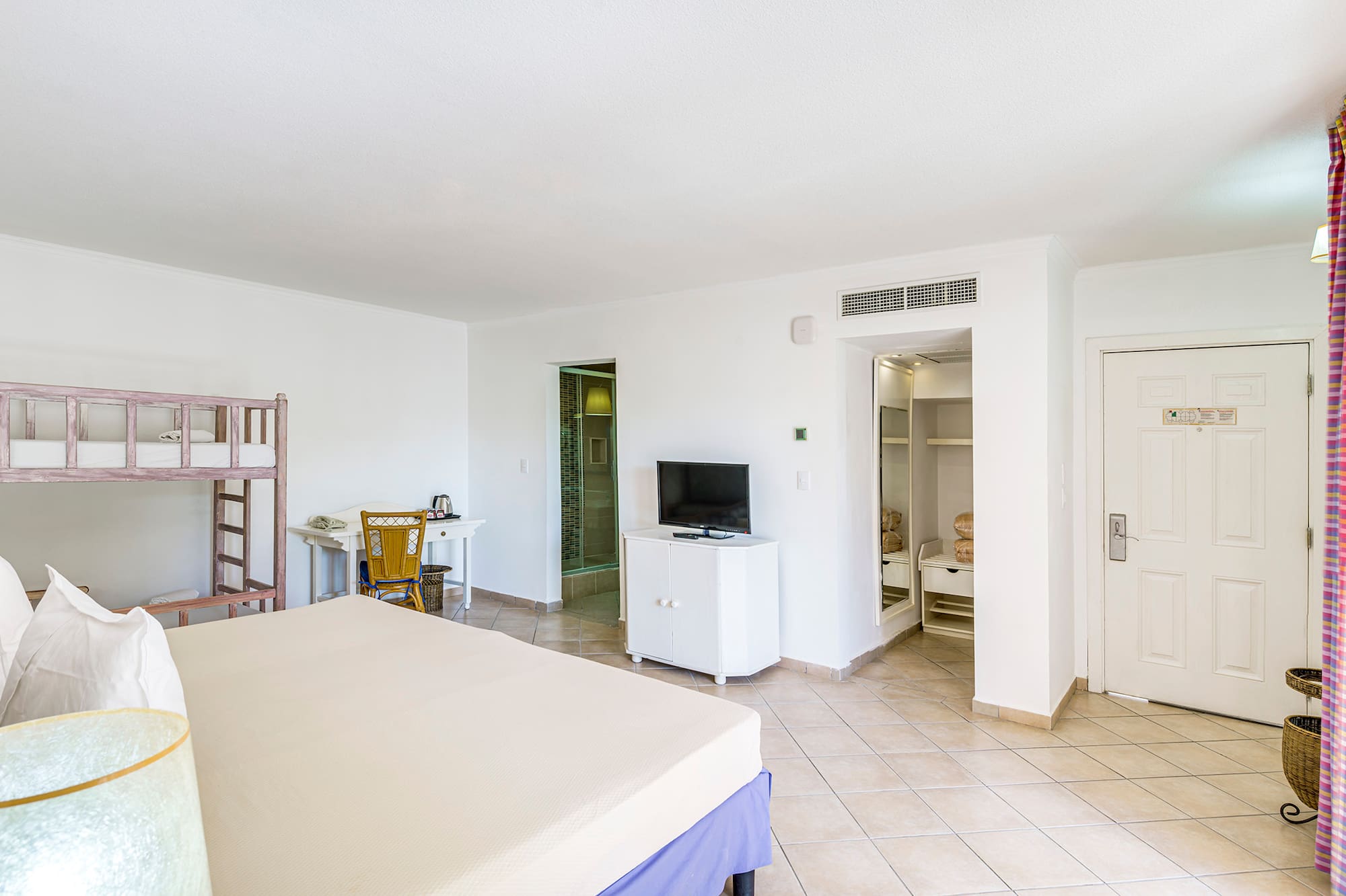 a room with a bed and a bunk bed