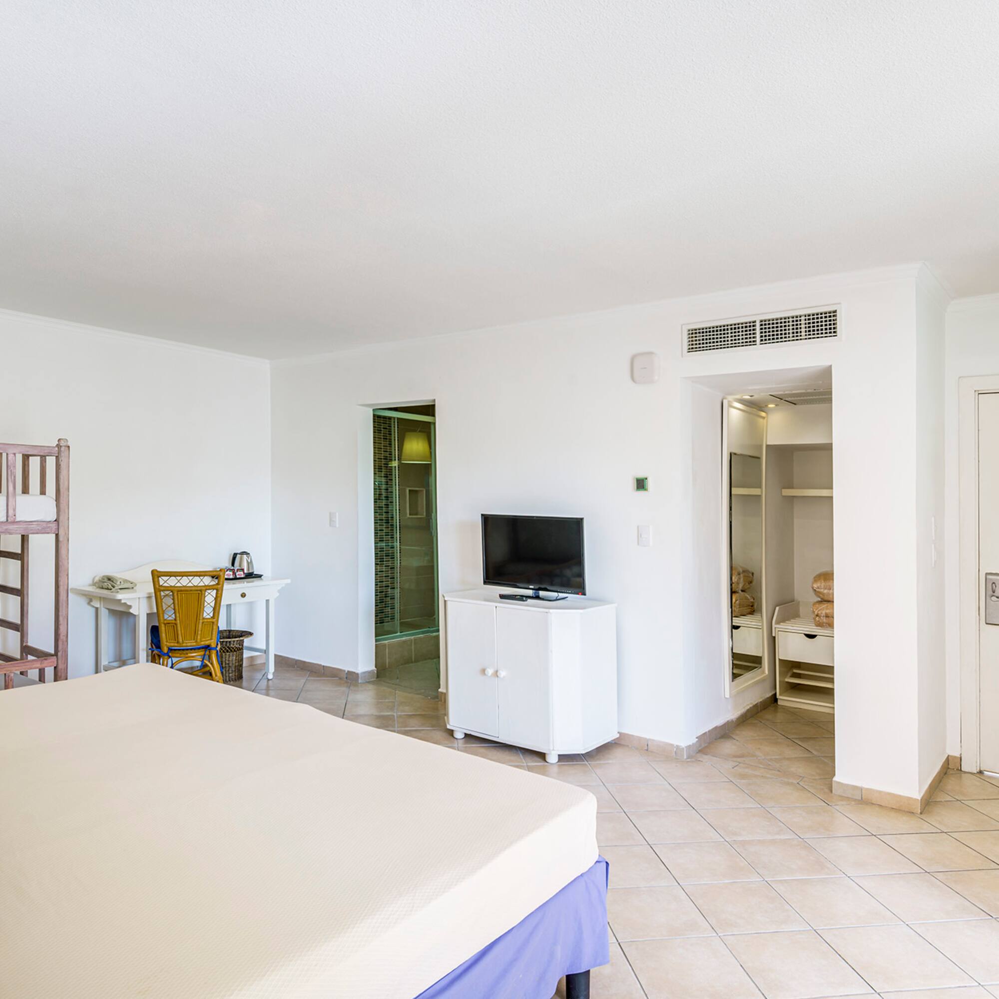 a room with a bed and a bunk bed