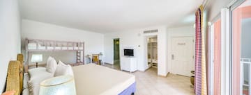 a room with a bed and a bunk bed