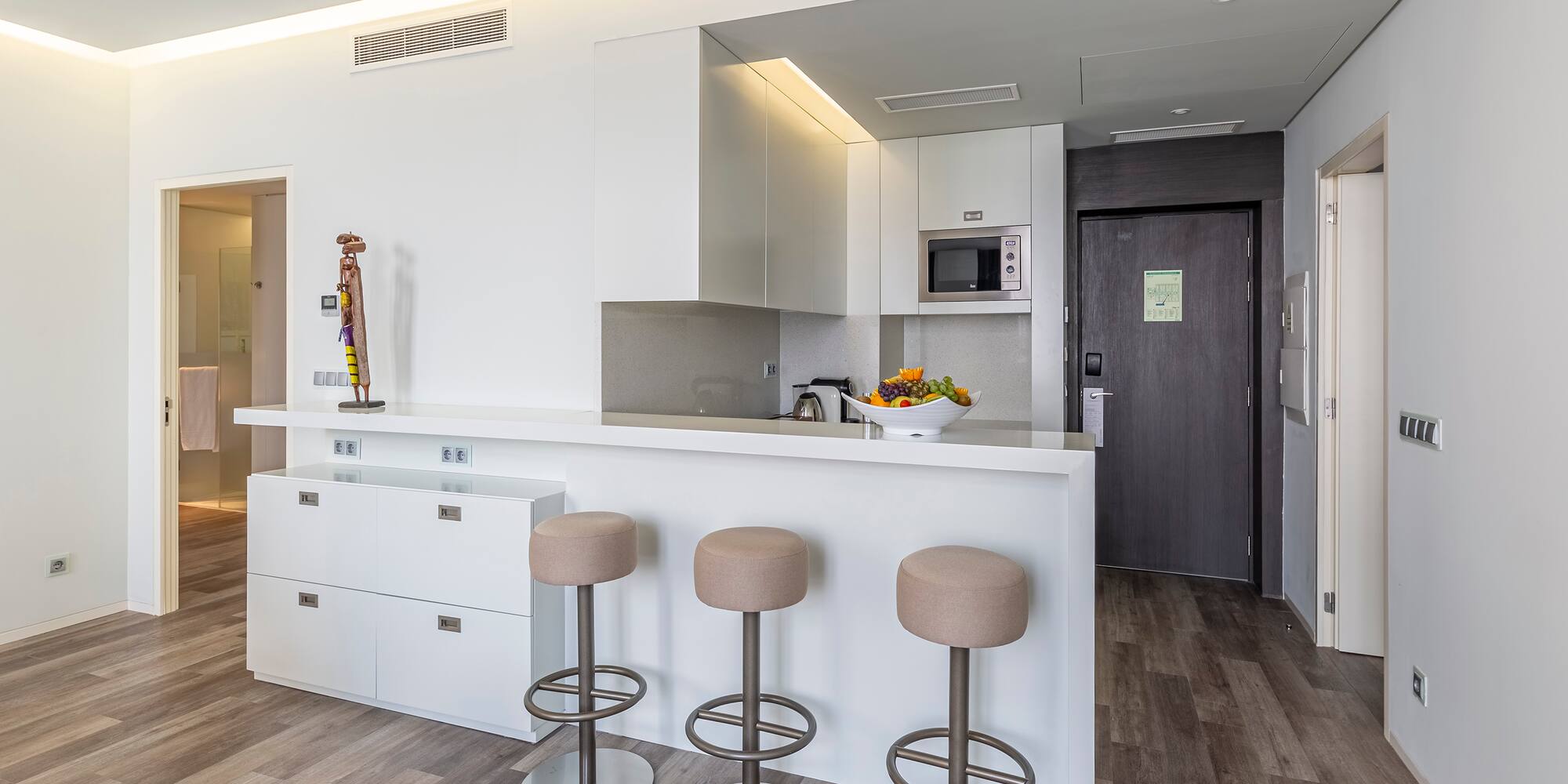 a kitchen with stools and a door