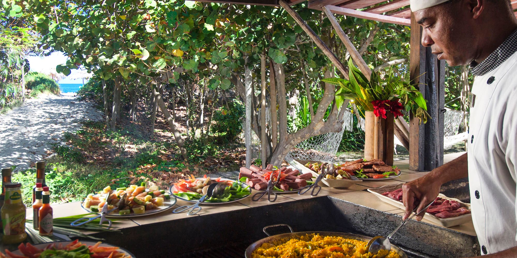 a man cooking food on a grill