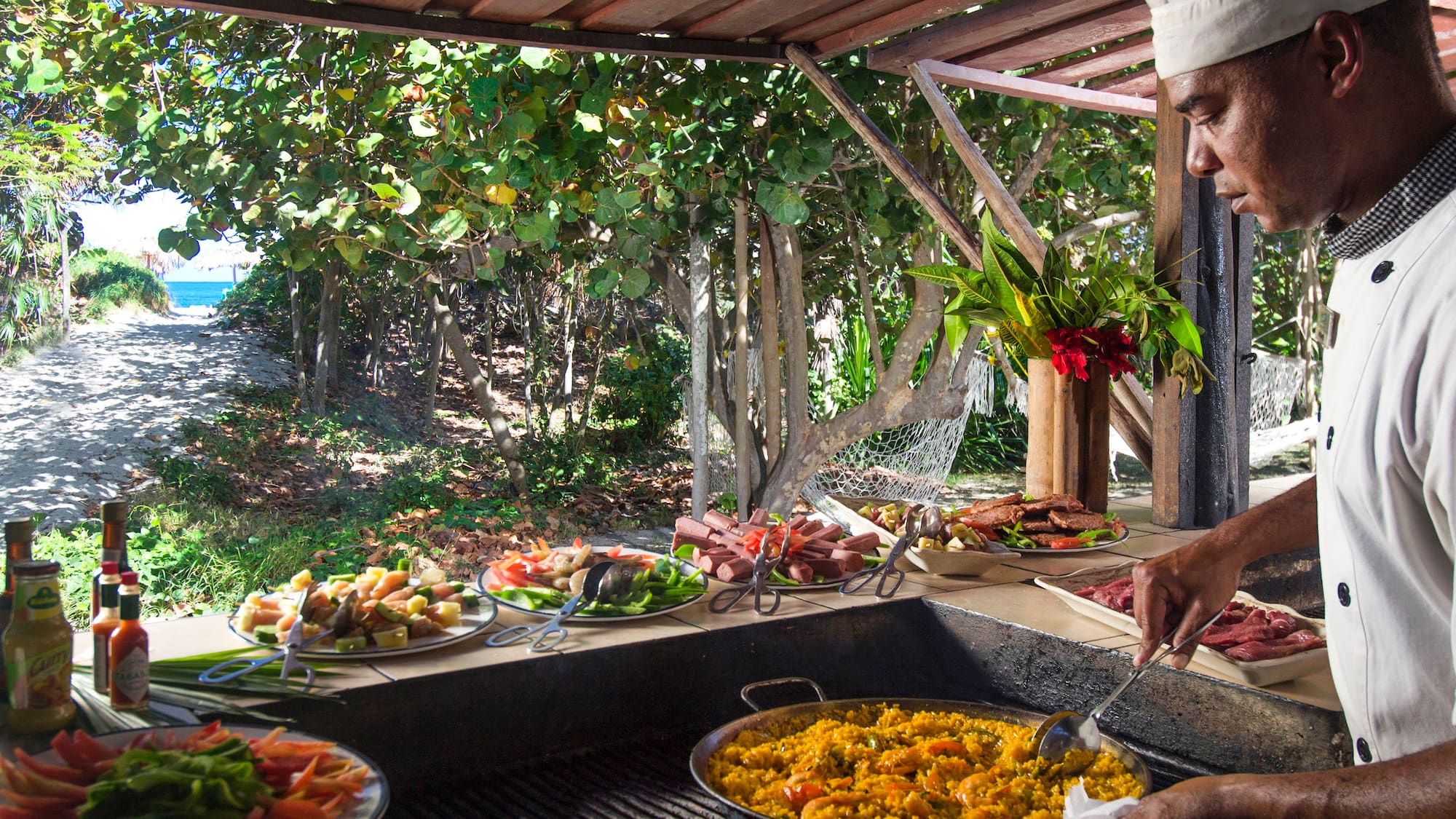 a man cooking food on a grill