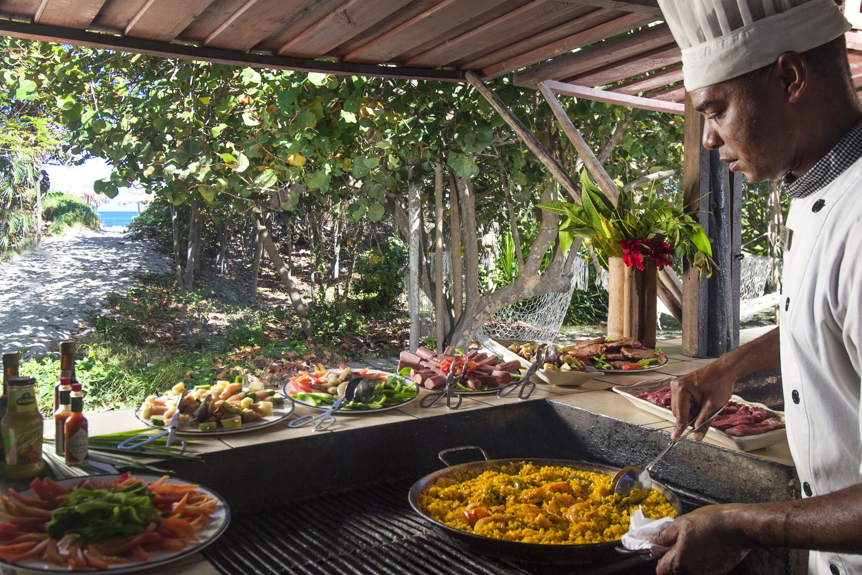 a man cooking food on a grill