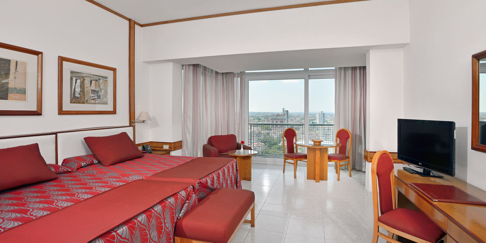 a room with a bed and chairs and a table