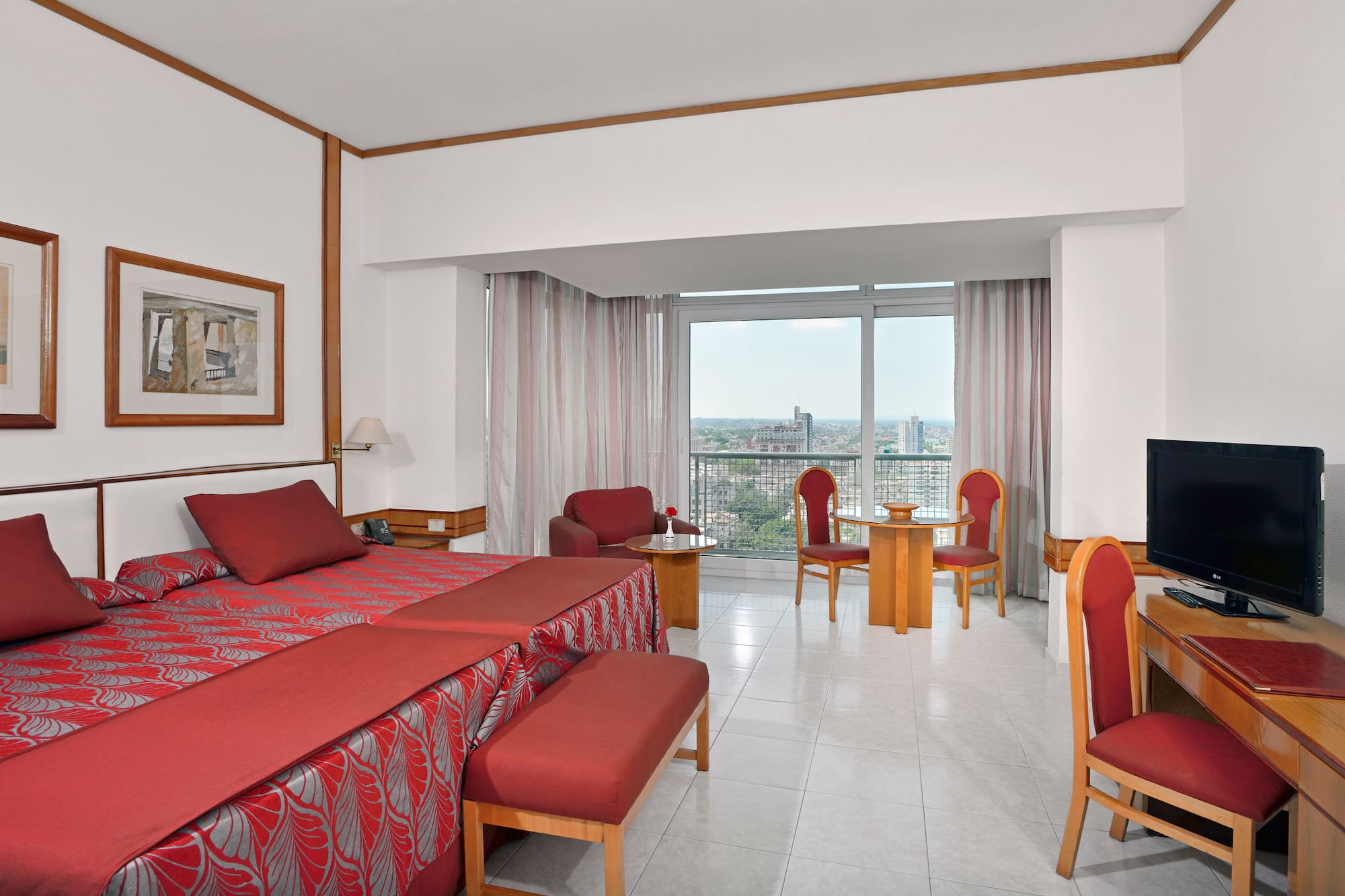 a room with a bed and chairs and a table