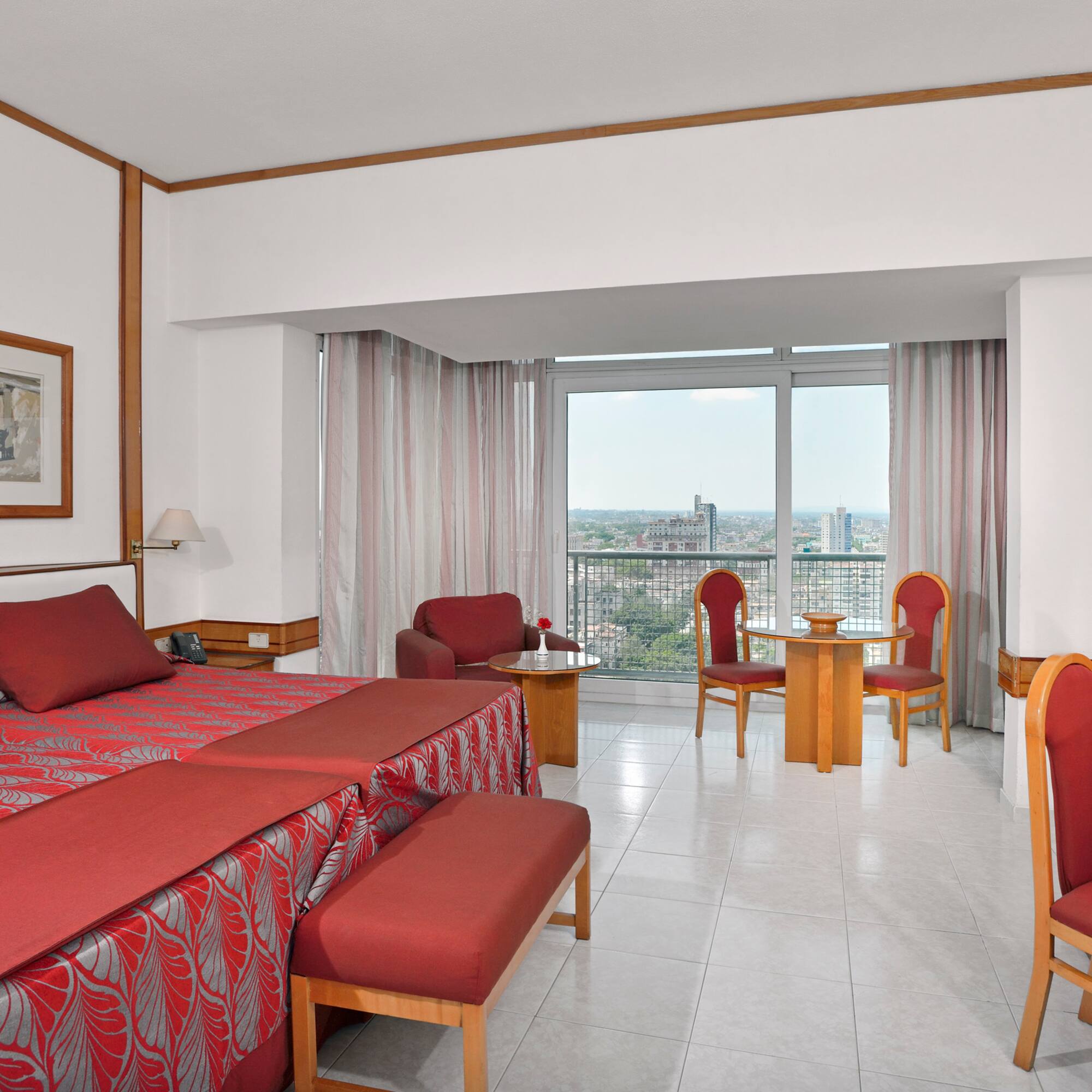 a room with a bed and chairs and a table