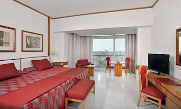 a room with a bed and chairs and a table