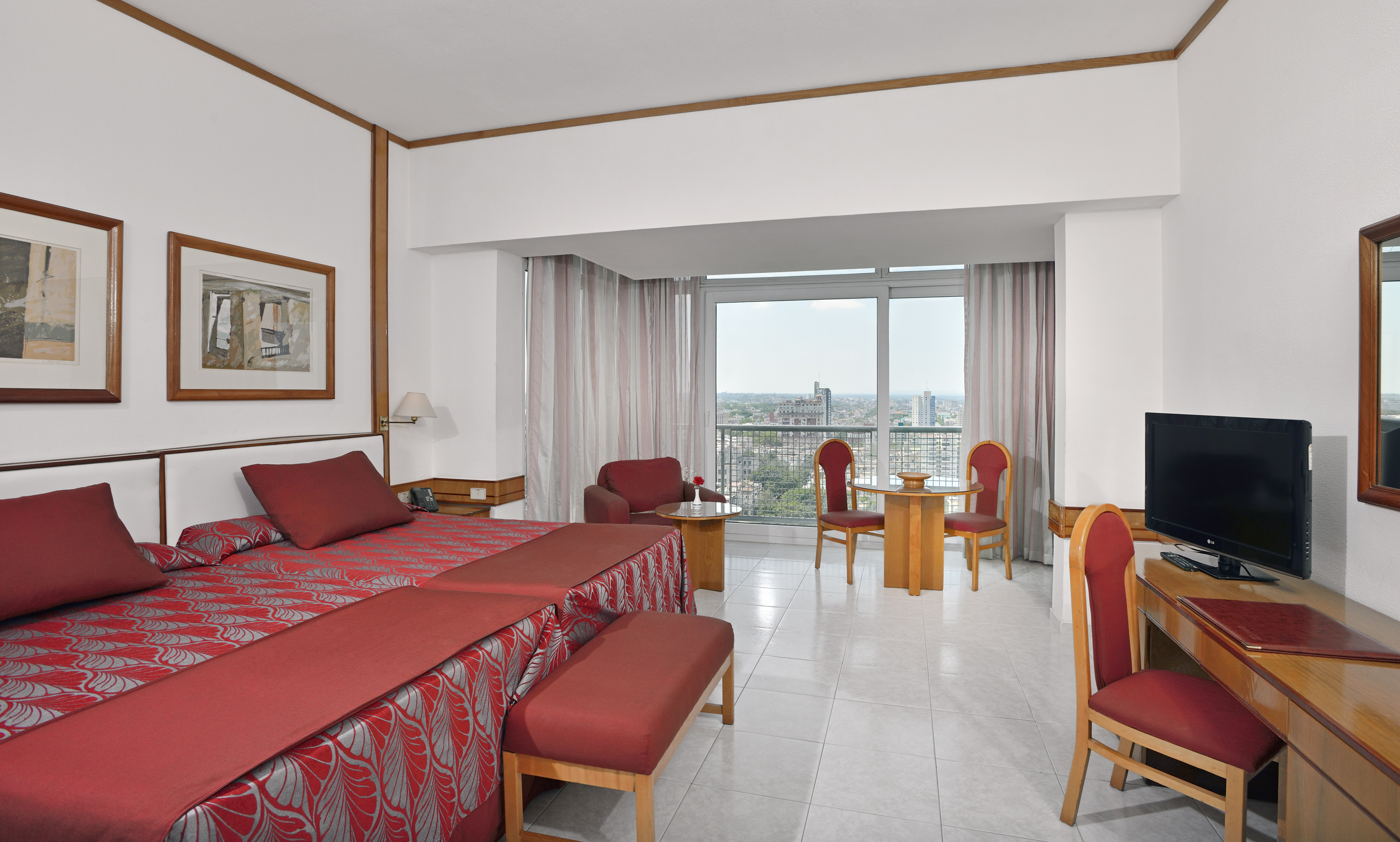 a room with a bed and chairs and a table