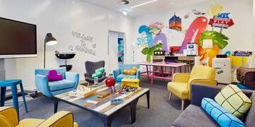 a room with colorful furniture and a table
