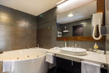 a bathroom with a tub and sink