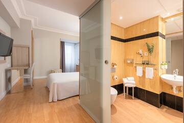 a room with a bed toilet and shower