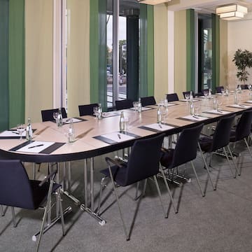 long table with chairs and a plant
