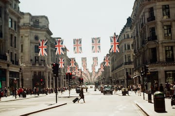 a street with flags from the ceiling
