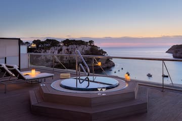 a hot tub on a deck overlooking a body of water