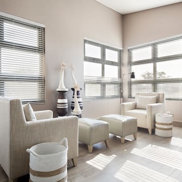 a room with a couch and chairs