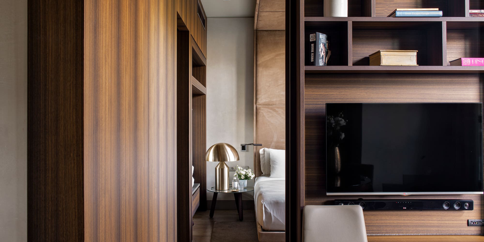 a room with a tv and shelves