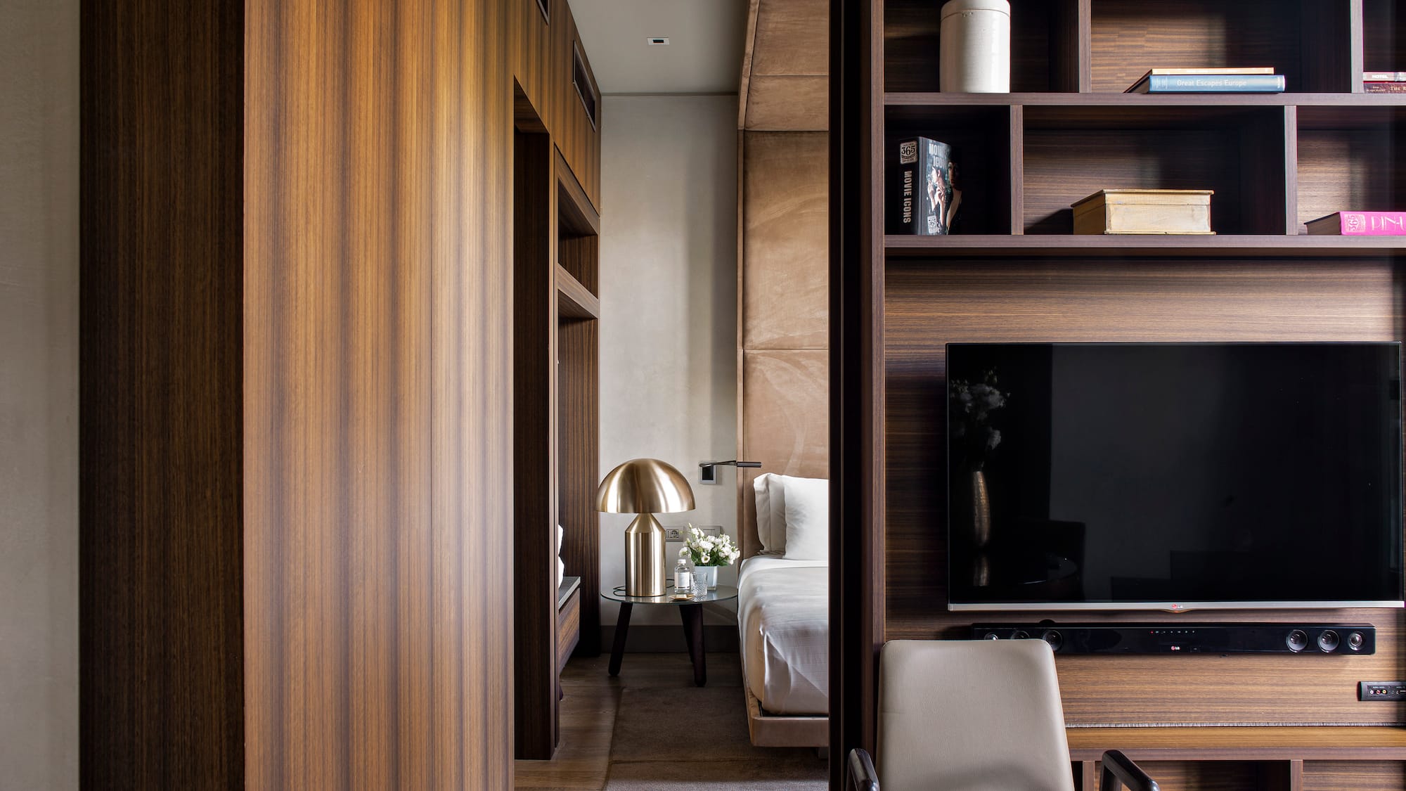 a room with a tv and shelves