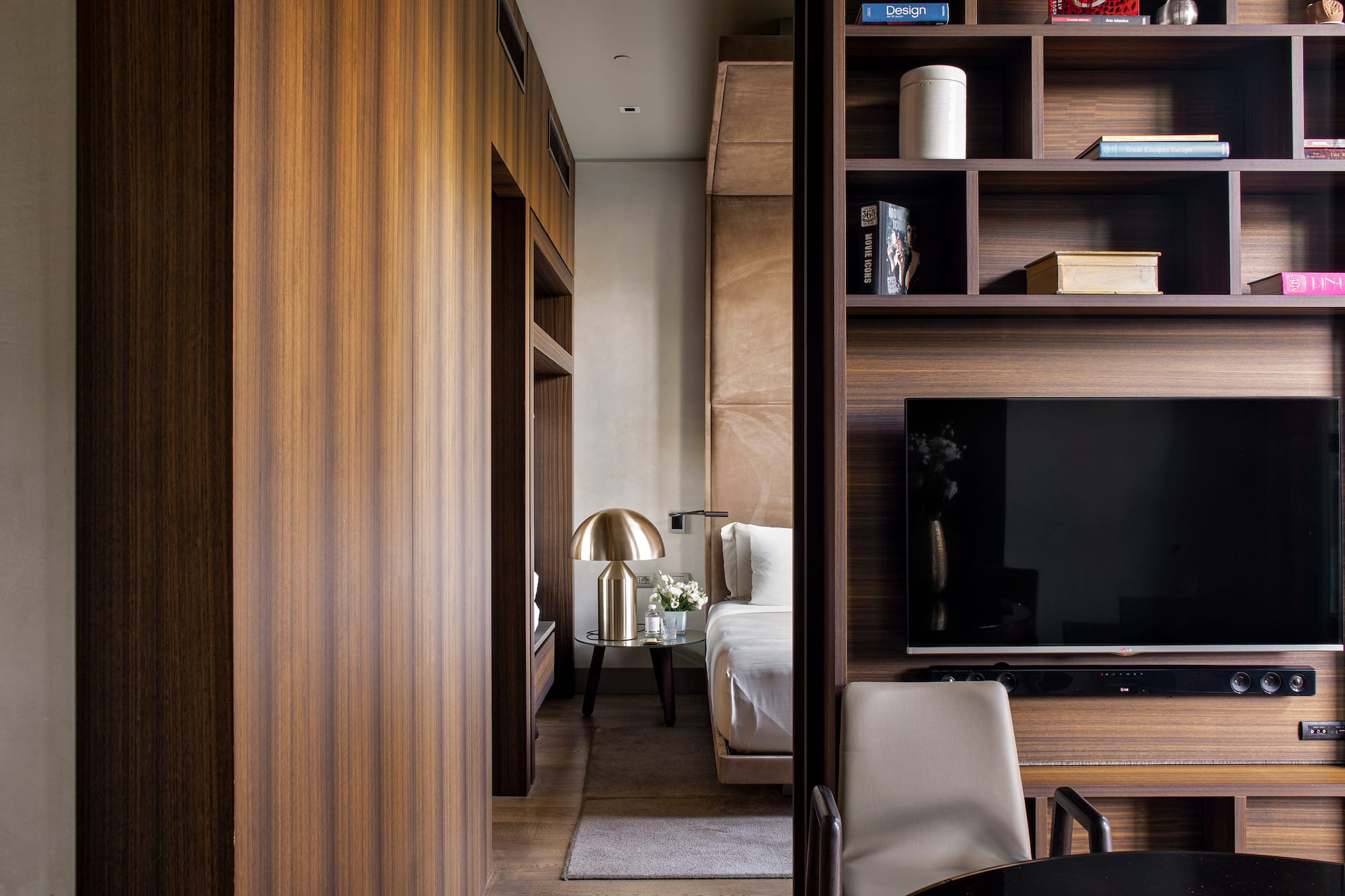 a room with a tv and shelves