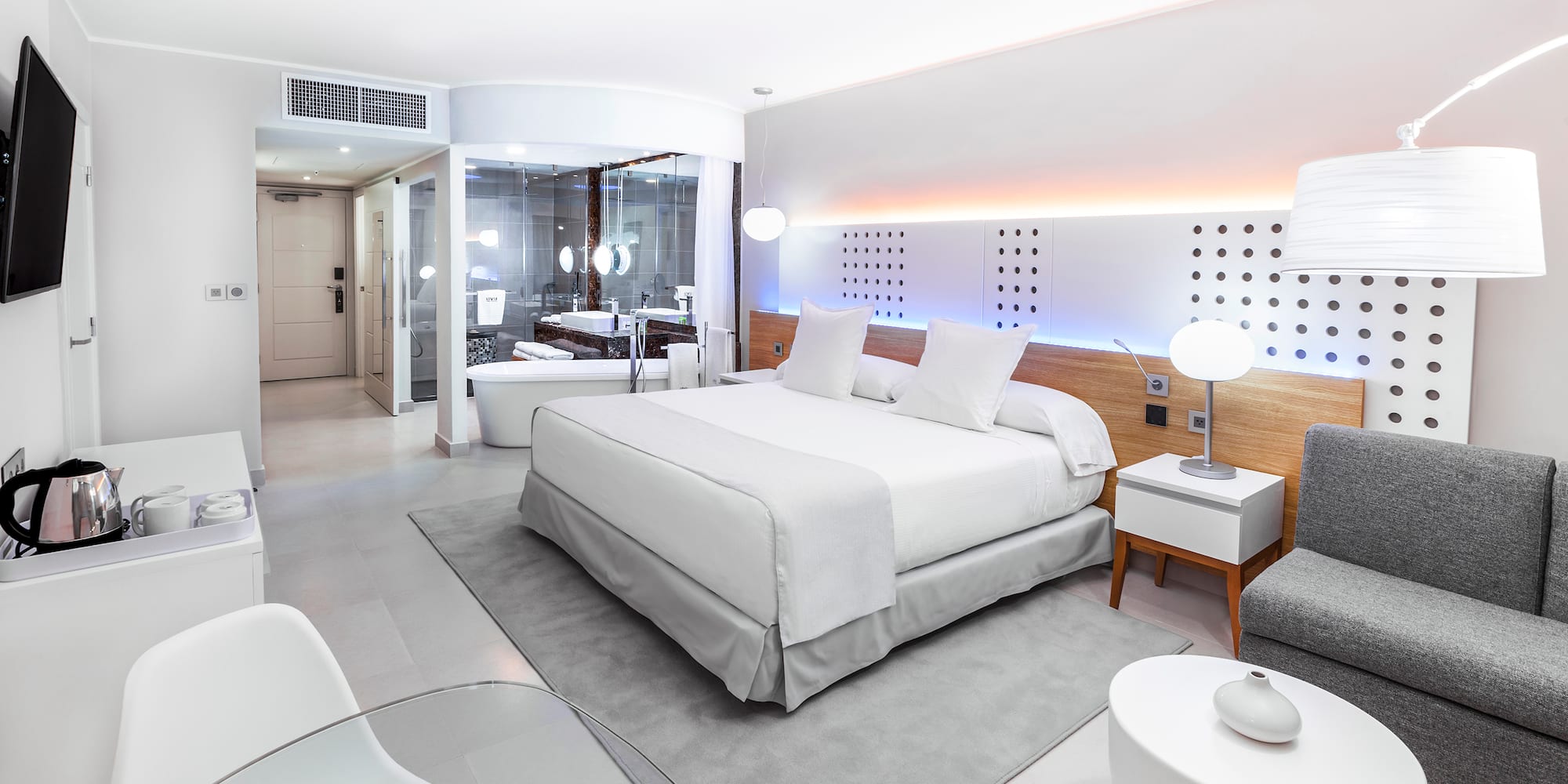 a bedroom with a bed and a tub